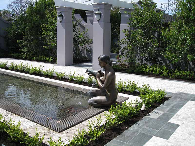 formal water feature with bronze sculpture of woman