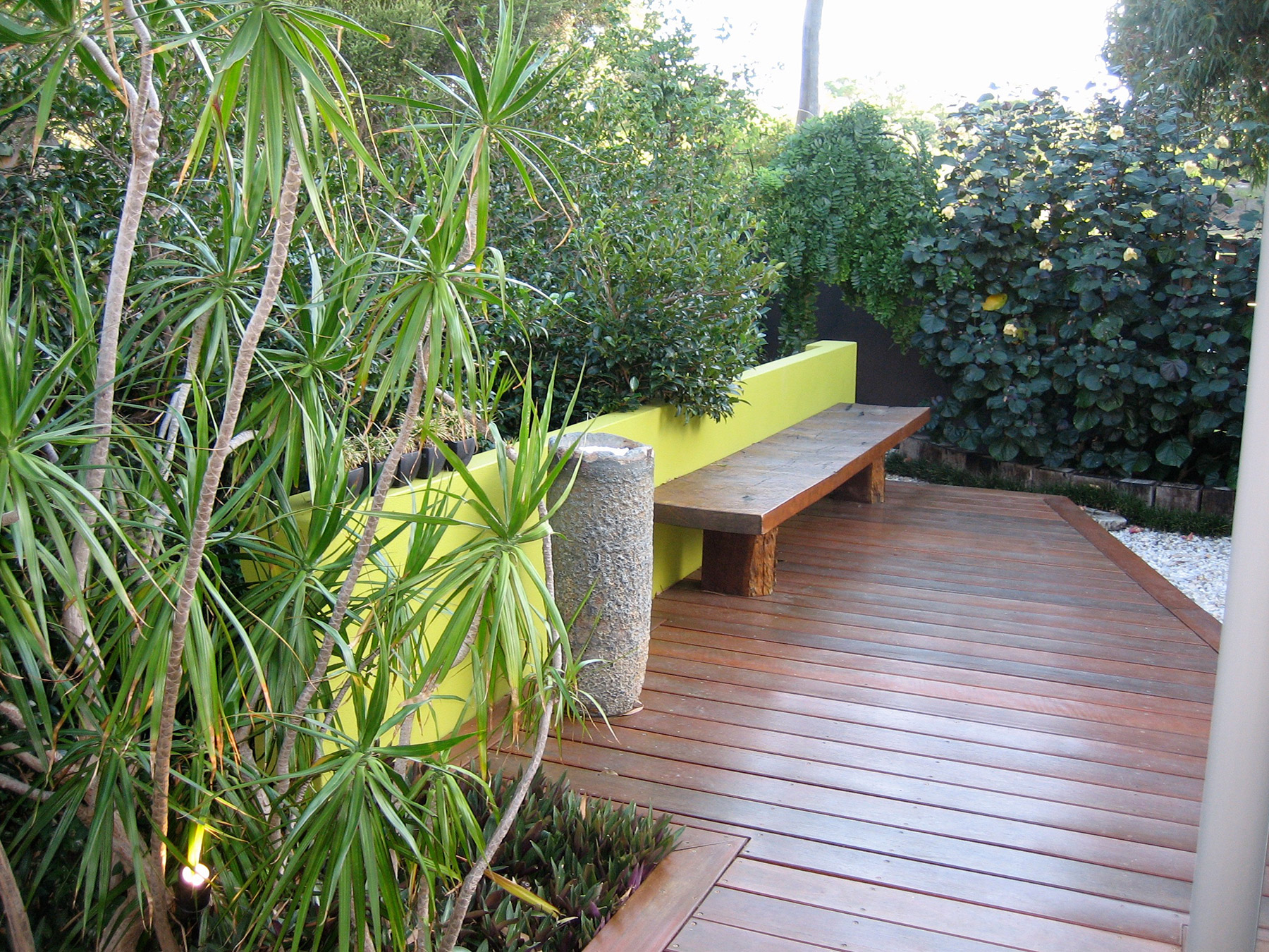 contemporary jarrah bench and crucible in courtyard garden