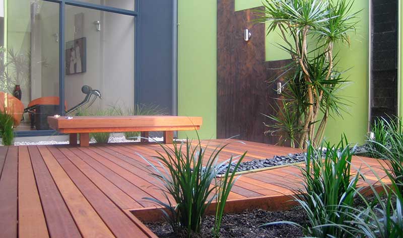 contemporary courtyard in subiaco with corten steel wall panels and timber decking