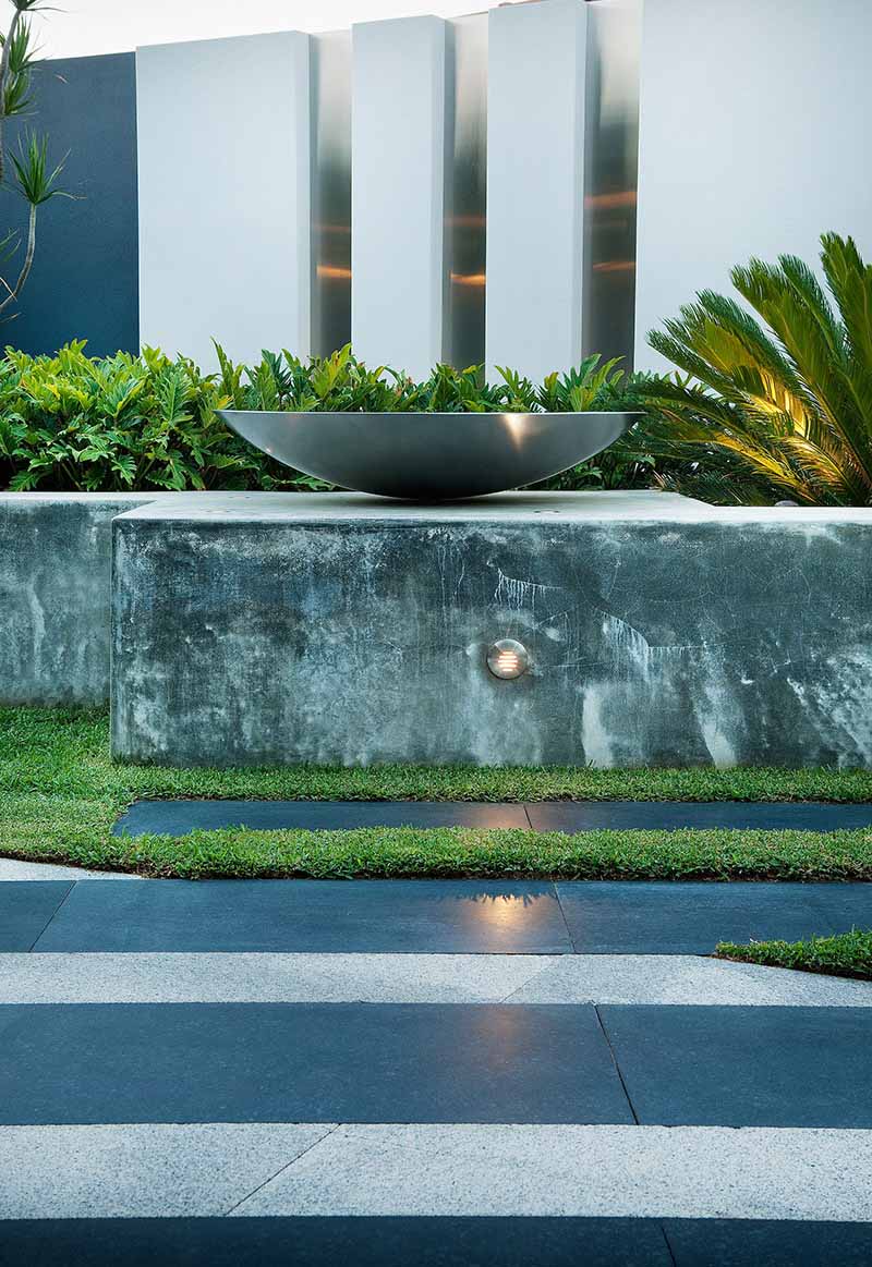 contemporary landscape design by Cultivart with concrete walls and stainless steel features