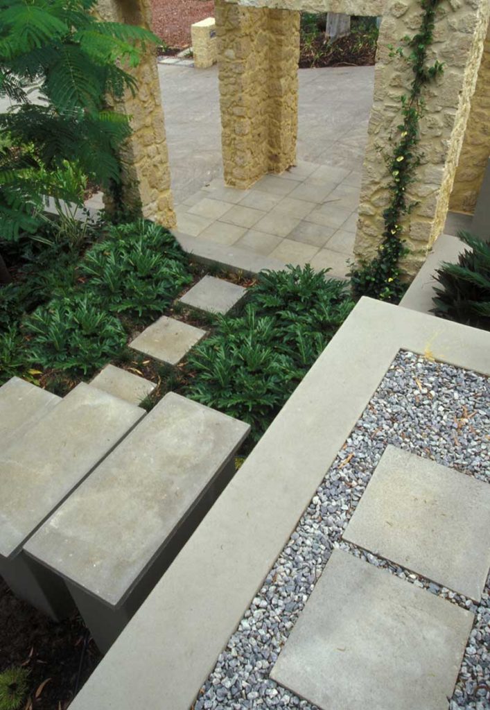 entry courtyard design in Swanbourne with limestone rubble gatehouse and freestanding steppers