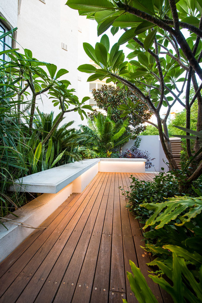 Outdoor cantilevered seat in lush garden
