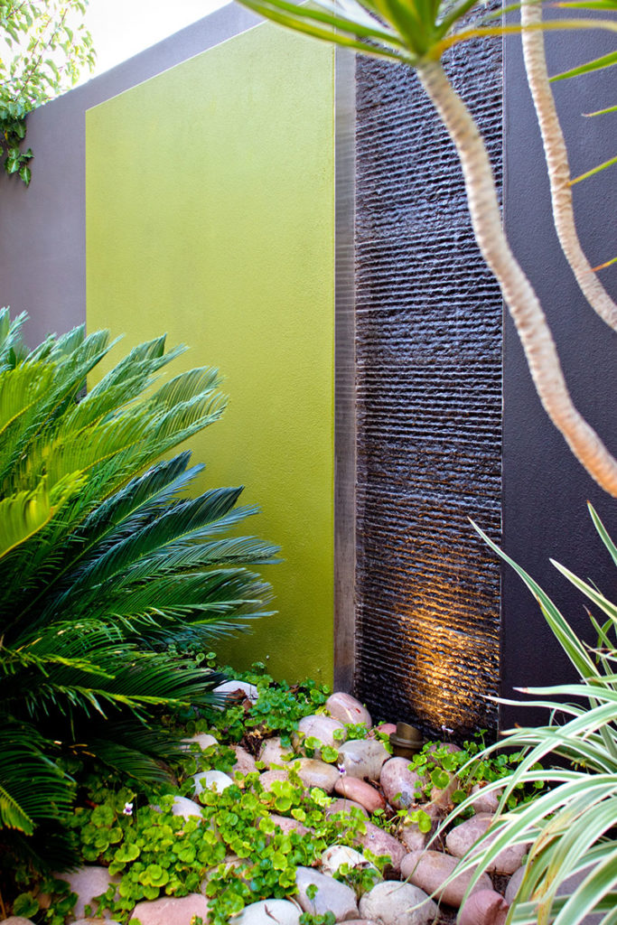 green wall with granite water wall flowing